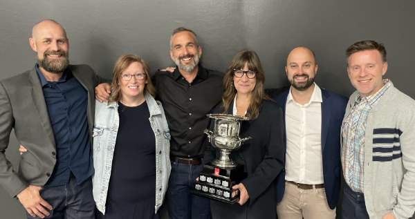 Margo Long accepts the MacGregor Cup from Roy Group’s Iain Duncan at a surprise presentation featuring YESS team members and some of her biggest fans.